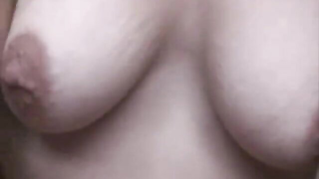 Closeup of sexy girl's pale big natural tits with brown nipples