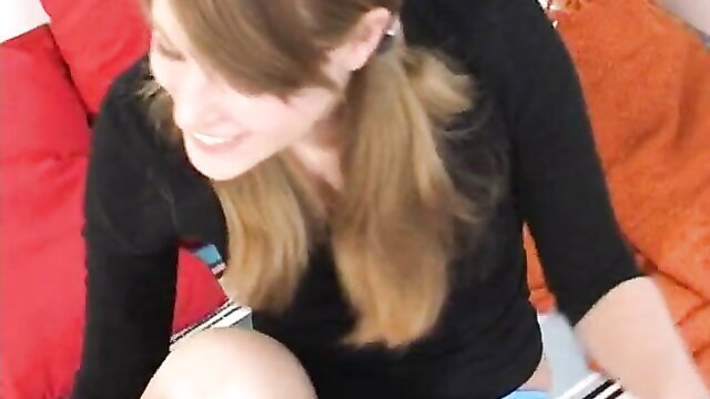 Amateur blonde Kitti in lingerie smiles teasingly on sofa, SoloPiger solo