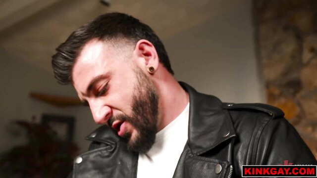 Ian Holms in leather jacket, tormenting Benvi in bondage fuck