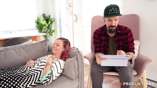 Sensual pink-haired cougar lounging seductively with bearded man on tablet