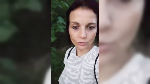 Brunette woman in zebra top on park walk, surprised face