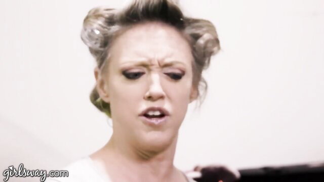 Dee Williams closeup shocked face in pinup curls, busty MILF tease