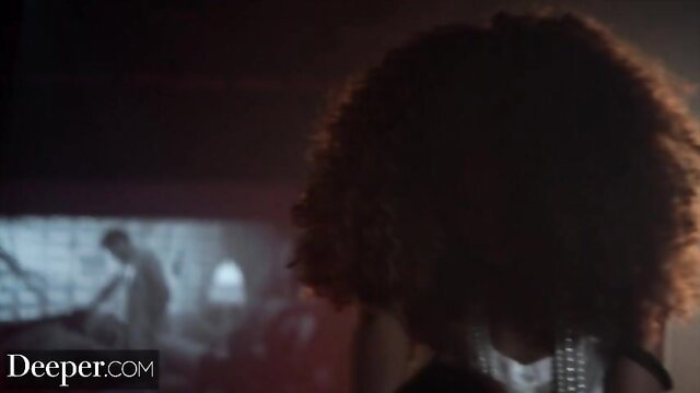Cecilia Lion curly hair back view in dimly lit adult scene