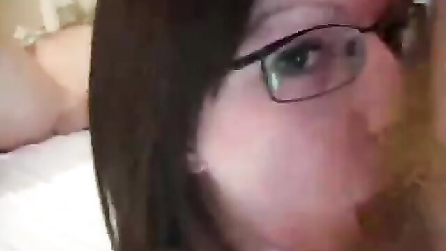 Closeup of horny MILF swinger with glasses and flushed cheeks