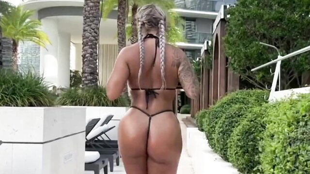Hayley with blonde braids shows off huge tanned ass in thong bikini