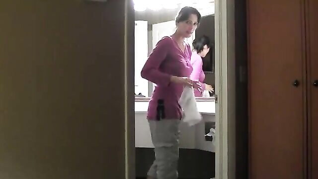 Zoey Holloway in pink top and gray pants in bathroom mirror, Road Trip With Stepmom 2