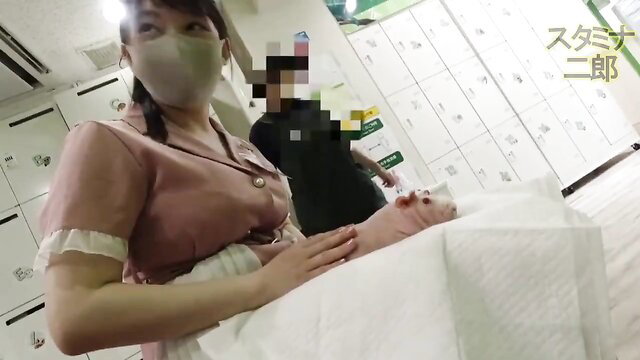 Japanese nurse in pink uniform handles pink dildo on table in JAV clinic