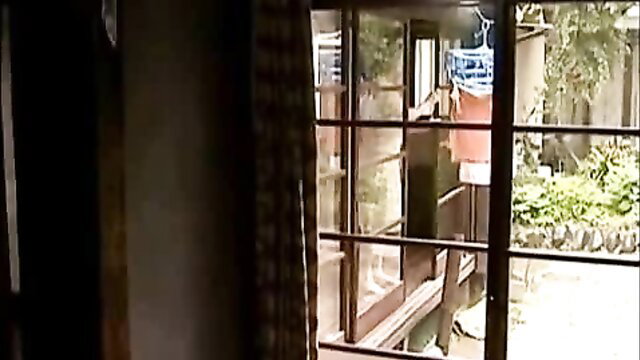 Taboo hot fun in Japan: Asian woman in red lingerie at window