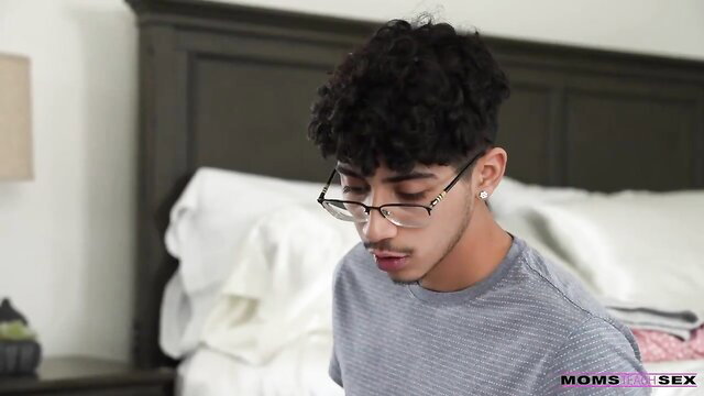 Curly-haired Latino guy in glasses on bed in hot mom sex thumbnail
