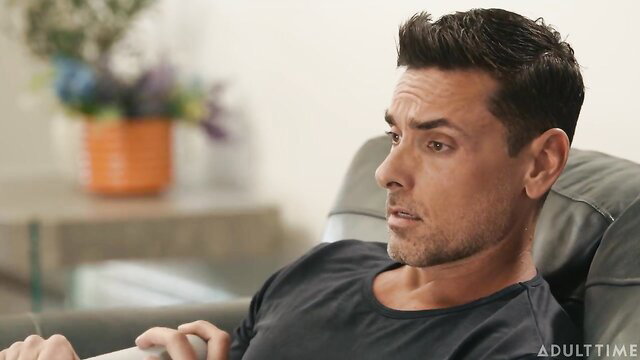 Julia James lounging pensively in black shirt, AdultTime