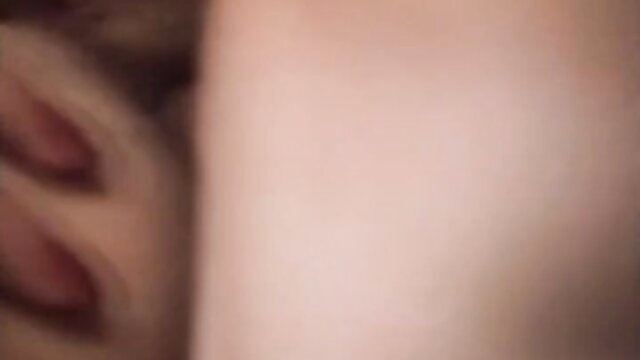 Blurry closeup of nude woman's pale breasts and red nipples in Color Climax slave market