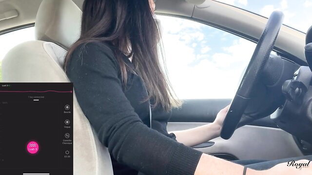 Asian babe in black sweater drives with Lush toy controlled by fan