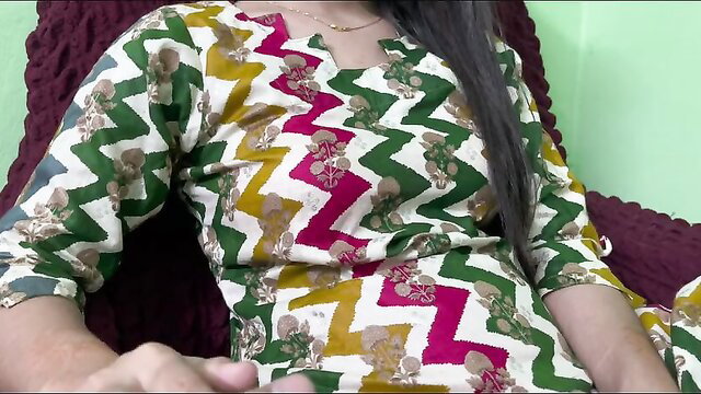 Desi Bhabhi in colorful salwar kameez teases with hand near cleavage