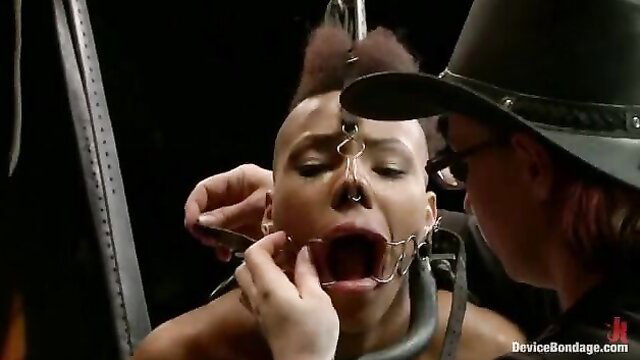 Nikki Darling gagged in bondage, mouth pried open by spider gag