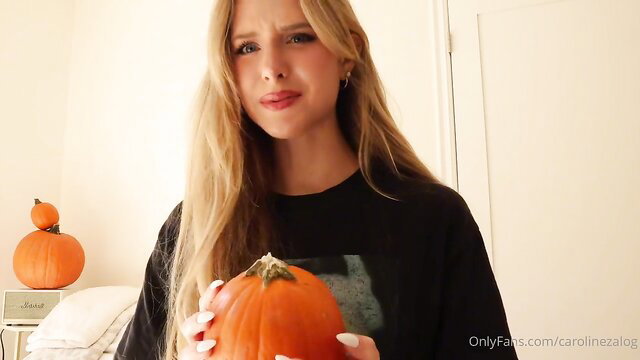 Caroline Zalog blonde in black hoodie holding pumpkin nude Halloween try on
