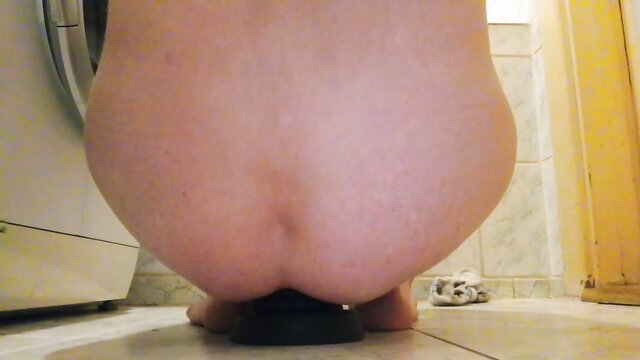 Pale BBW woman kneeling nude with huge ass on black butt plug toy