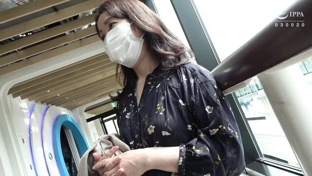 Japanese mature woman in black dress and mask at public gate
