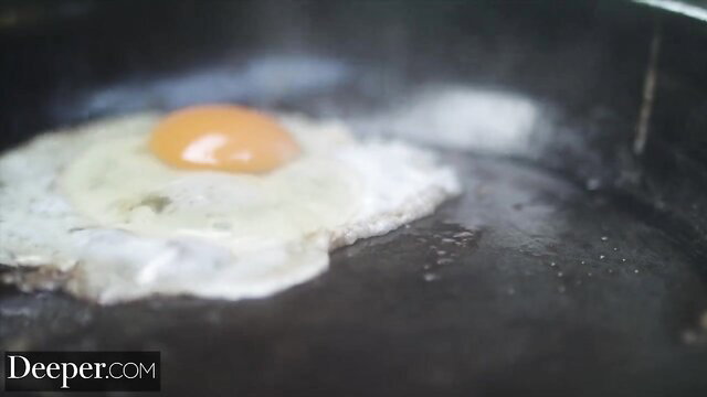 Cecilia Lion sunny side up egg frying in pan closeup