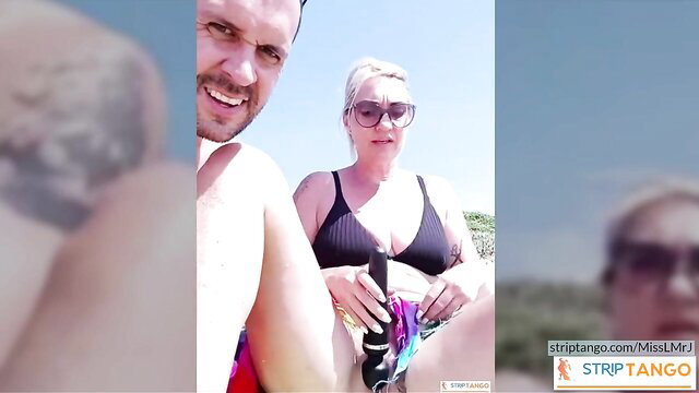 MissLMrJ blonde couple beach erotic display holding toys