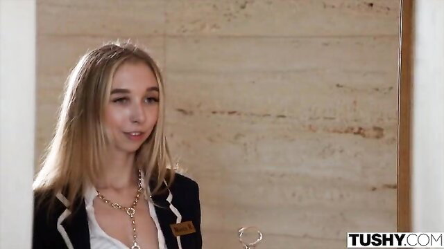 Nicole Doshi in Tushy uniform, blonde hair smiling closeup