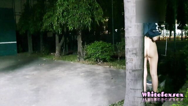 Thai teen baring huge ass outdoors by tennis court