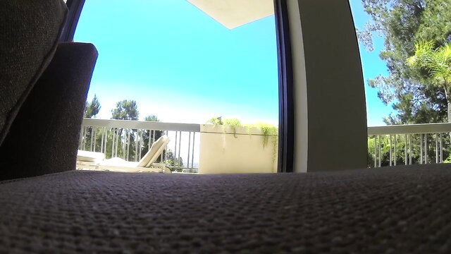 Sunny balcony view with lounge chair, outdoor adult scene tease