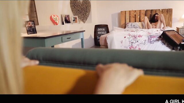 Arwen Gold naked on bed in strap-on lesbian play