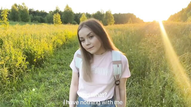 Alexa Mills in field at sunset, pink shirt jeans backpack, outdoor POV tease