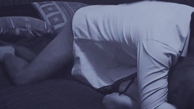 Submissive trans bent over bed in lingerie, nude ass exposed in dim light