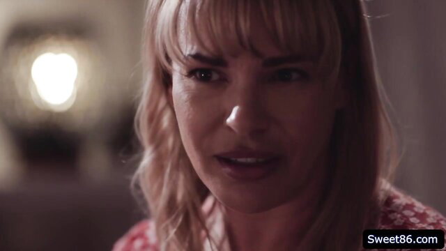 Busty blonde MILF Dana DeArmond closeup gaze in adult video