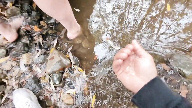 Stepmom's bare feet in creek with stepson's hand, outdoor adventure tease