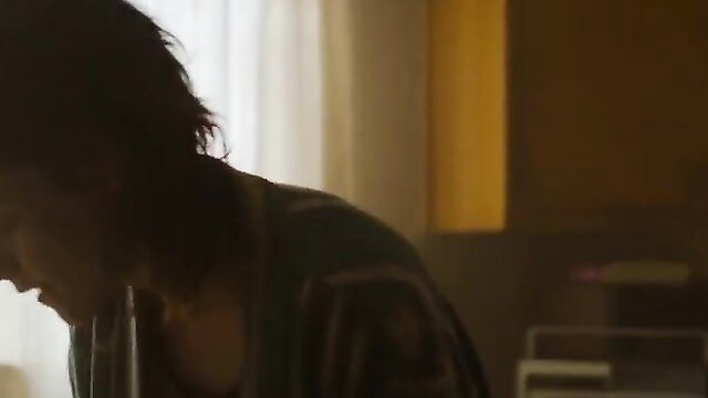 Katy O'Brian silhouette profile in shadowy LLB 2024 nude scene with Kristen Stewart