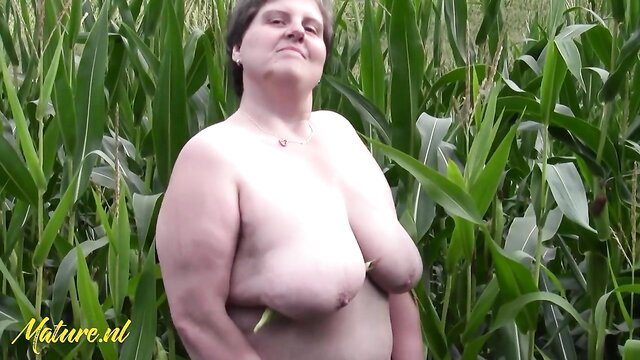 Nude big tits retro German woman smiling in cornfield outdoors