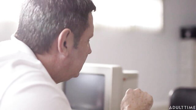 Kristen Scott closeup profile at retro computer, tense grip