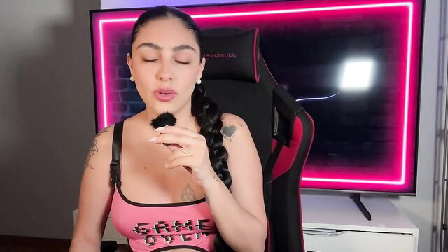 Hot Latina gamer girl in pink tank top teases with makeup brush blowjob style