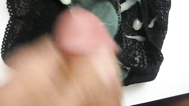 Closeup of woman fingering pussy with cum dripping on black lace panties