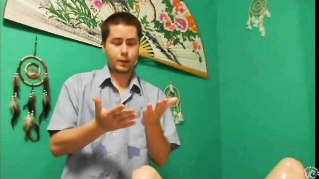 Man massages hot girl's bare legs on table before she squirts