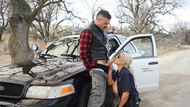 Bridgette B as police MILF kneels blowing guy outdoors by cop car
