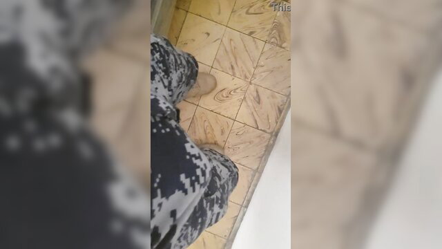 Mexican marine in camo pants showing feet on tiled floor