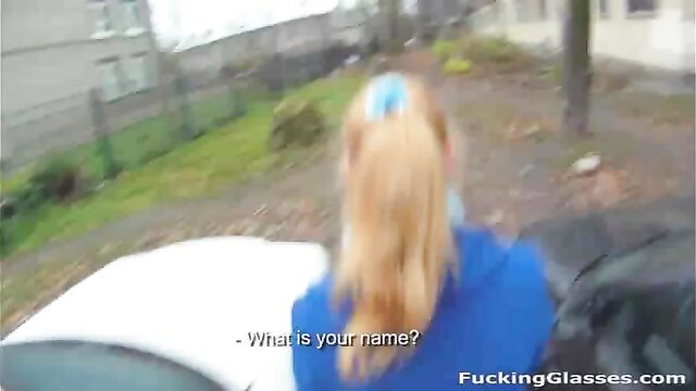 Blonde teen in blue top and ponytail at car, outdoor amateur hookup tease