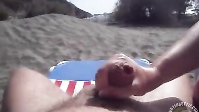 Amateur handjob on beach with explosive orgasm on American flag towel