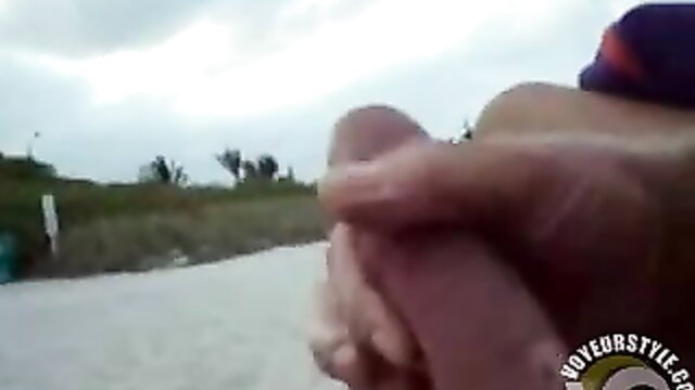 Man's erect cock wanked publicly on sunny beach day