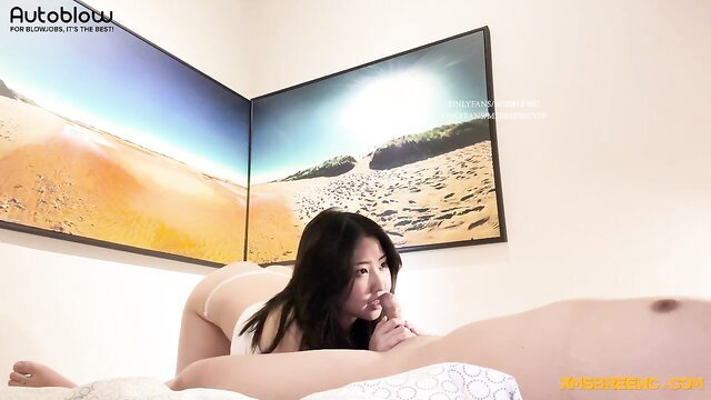 Asian babe in lingerie kneels doggy on bed sucking cock watching porn