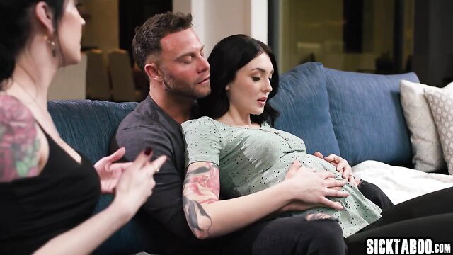 Pregnant brunette held by tattooed husband as instructor watches