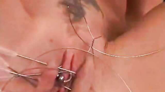 Freakish vagina sewing fetish closeup with needles and wires