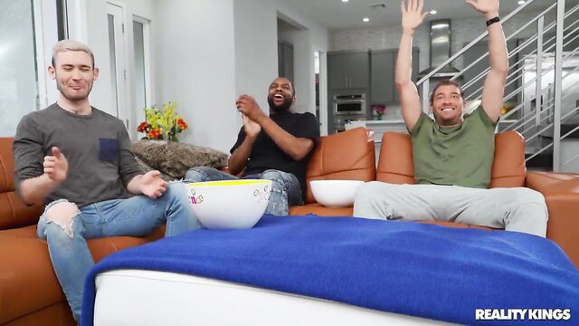 Three hot men laughing on couch in Reality Kings scene with Aften Opal