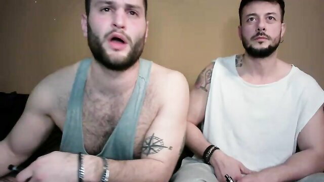 Two muscular bearded men cuddling shirtless in gay amateur video