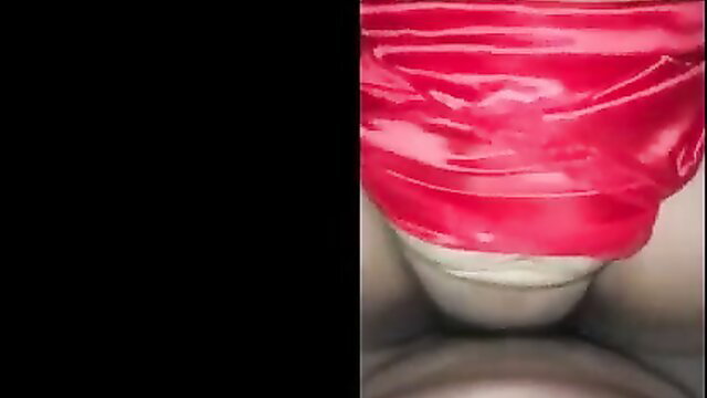 Closeup of woman's shaved pussy wrapped in shiny red satin fabric