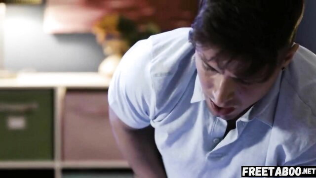Creepy guy sneaks in white shirt, intense closeup face in dim room