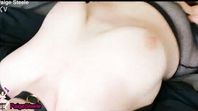 Curvy redhead Paige Steele in fishnet lingerie exposing huge tits closeup